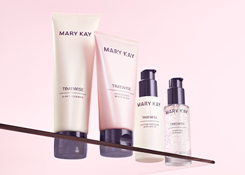 TimeWise Miracle Set featuring four products sitting on a glass shelf pictured over a light pink background
