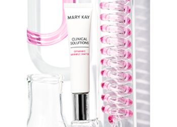 Dynamic Wrinkle Limiter tube styled next to a mix of science beakers and tubes filled with pink liquid