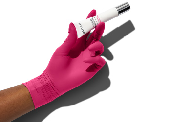 A pink medical gloved hand holding Dynamic Wrinkle Limiter topical cream in the same way one would hold an injection treatment